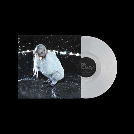 Vinyl record with cover art of a person in white, surrounded by rain.