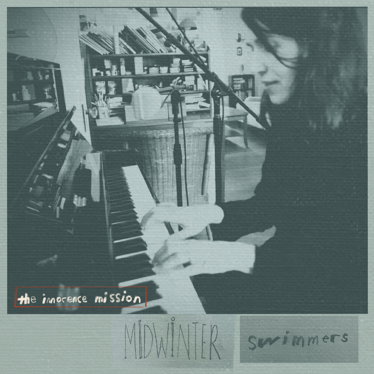 Black and white album cover featuring a woman with a violin and piano.