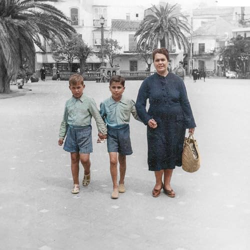 Black and white photo of a woman with two young boys.