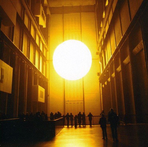 CD cover: Large, bright circle in a vast, yellow-lit architectural space.