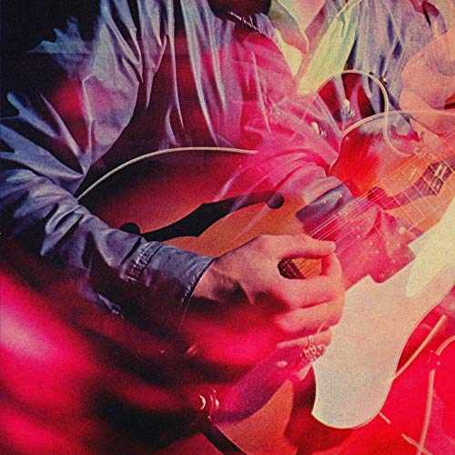 Man playing guitar with red and yellow light effects overlayed on image.