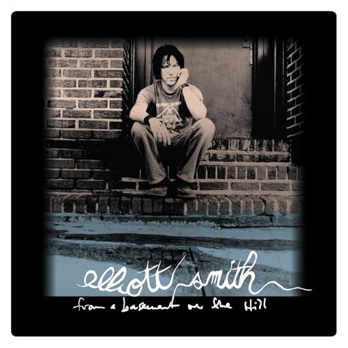 Elliott Smith album cover: artist seated on brick steps, muted tones.