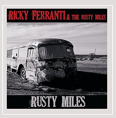 CD cover: rusty vintage camper in a desolate landscape.