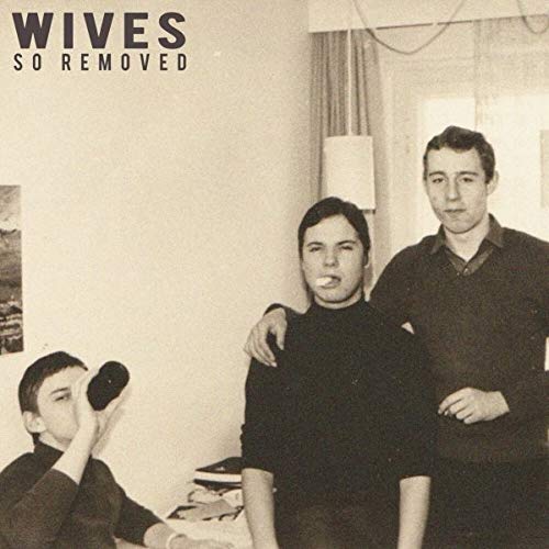 Black and white vinyl album cover featuring three people indoors.
