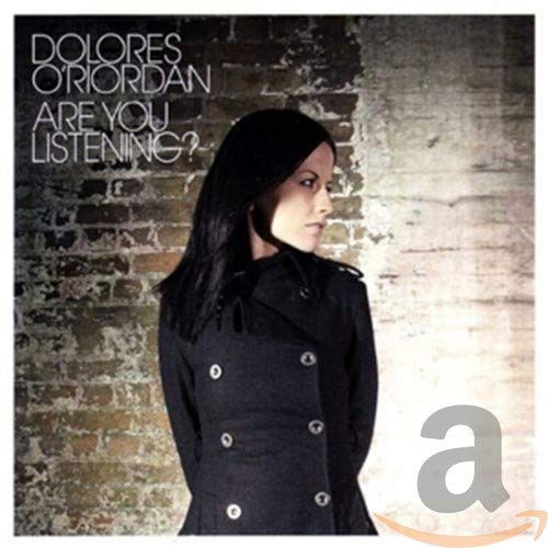 Dolores O'Riordan album cover, portrait of a woman in a black coat.
