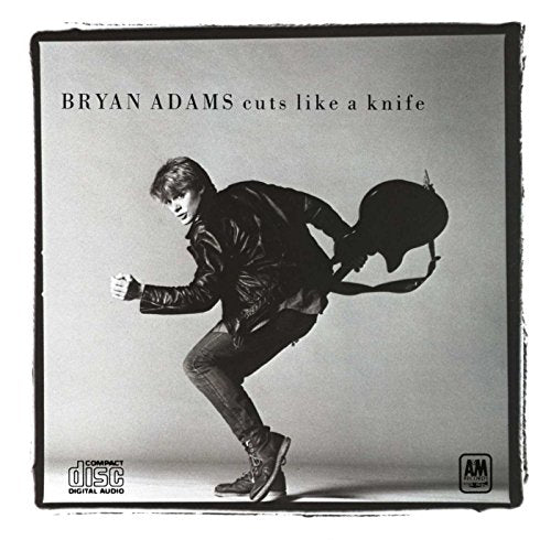 Bryan Adams album cover, black and white, artist with guitar.