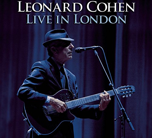 Leonard Cohen in a suit playing guitar on stage, CD cover.