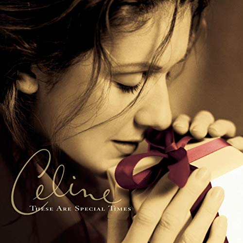 Celine Dion album cover: close-up portrait with a red ribbon gift.