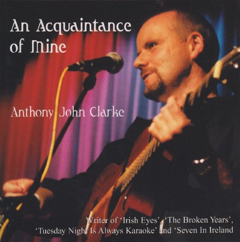 CD cover: Anthony John Clarke with guitar and microphone on stage.