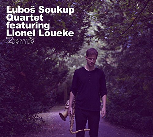 Album cover: Man with saxophone walking down a forest path.