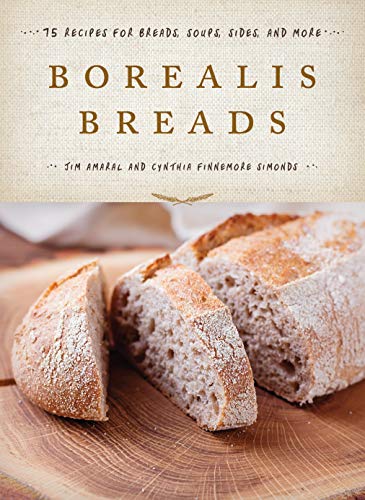 Cookbook cover featuring rustic loaves of bread on a wooden board.