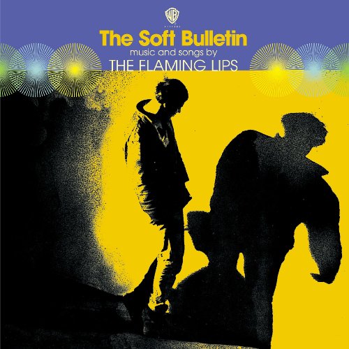 Album cover for The Flaming Lips’ “The Soft Bulletin” with silhouetted figures.