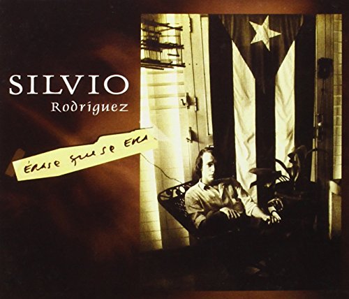 Silvio Rodriguez album cover with a man sitting in front of a flag.