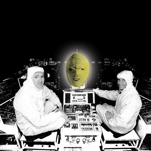 Two figures in white suits with a floating yellow face in space.