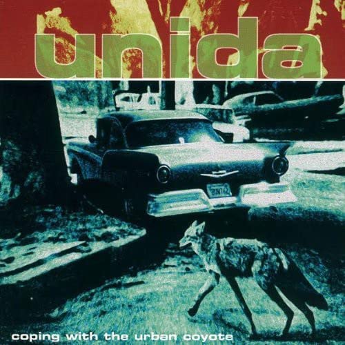 Vinyl album cover: "Unida" with a coyote and vintage car image.