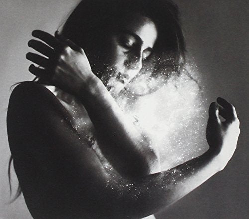 Black and white portrait of a woman with sparkling dust effects.