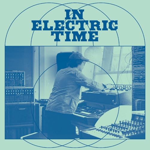 Album cover: man at vintage electronic equipment, blue and white design.