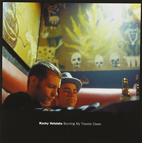 CD cover: two men in a booth with skull and floral mural.
