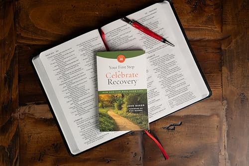 Book titled “Your First Step to Celebrate Recovery” rests on an open Bible.