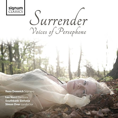 CD cover: woman in white lying in a forest, titled "Surrender".