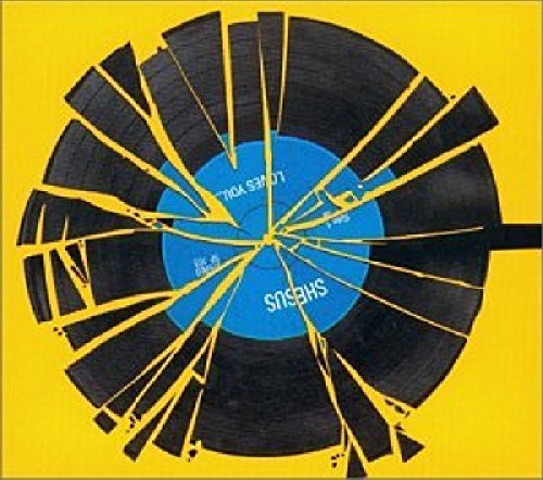 CD cover with a shattered vinyl record design, blue center label.