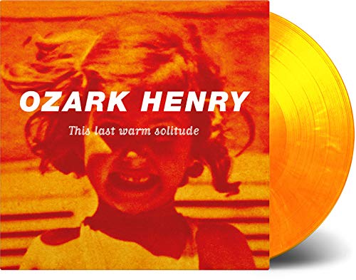 Ozark Henry album cover with a child’s portrait and orange vinyl record.