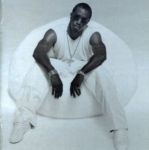 Black and white portrait of Puff Daddy seated in a large beanbag chair.