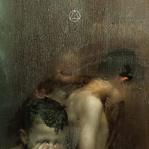 CD cover with a blurred, shadowy figure seen through textured glass.