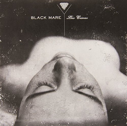 Black and white album cover featuring a close-CS-up of a person's closed eyes.