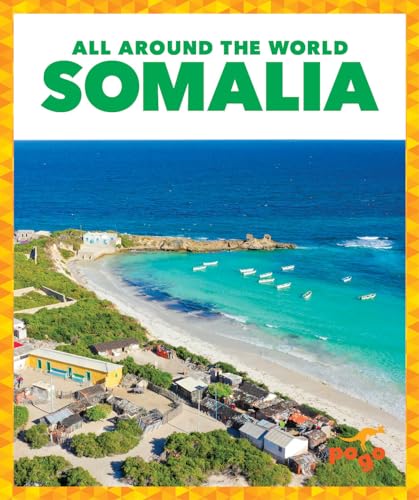 Aerial view of a beach in Somalia with boats and buildings near the shore.