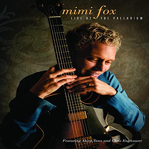 Mimi Fox playing a guitar on the DVD cover, "Live At The Palladium.
