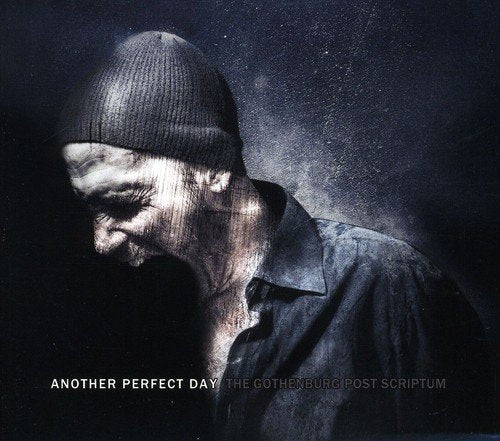 CD cover: man in beanie looking down, dark and textured background.