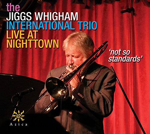 Jiggs Whigham playing trombone on CD cover, red curtain backdrop.