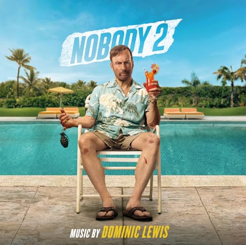 A man in a floral shirt sits by a pool holding a cocktail and grenade.