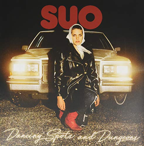 Album cover featuring a person in a leather jacket and headscarfS standing before a car.