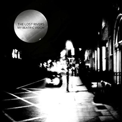 Black and white album cover with a large moon and street scene.