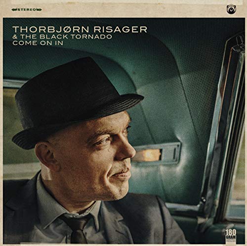Vinyl LP cover featuring a man in a hat looking out a window.
