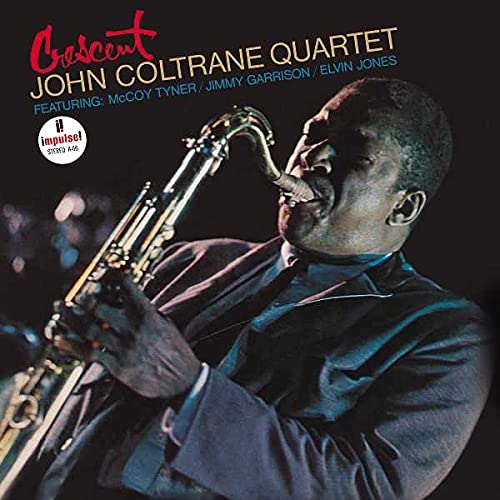 John Coltrane playing a saxophone on the album cover, "Crescent.
