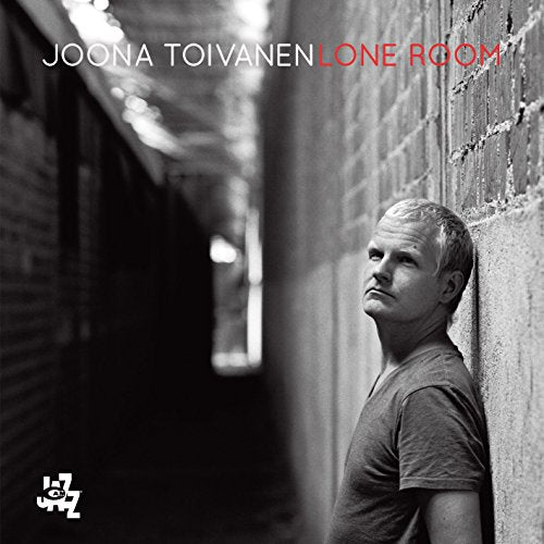 Black and white album cover featuring Joona Toivanen leaning against a brick wall.
