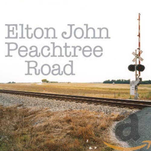 Album cover for Elton John's Peachtree Road featuring railroad tracks and a crossing signal.