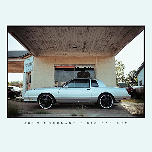 CD cover featuring a white car parked under a gas station awning.