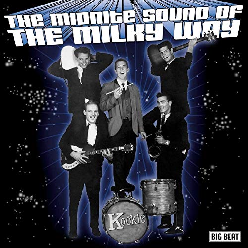 1960s band in suits poses against a starry, dark blue background.