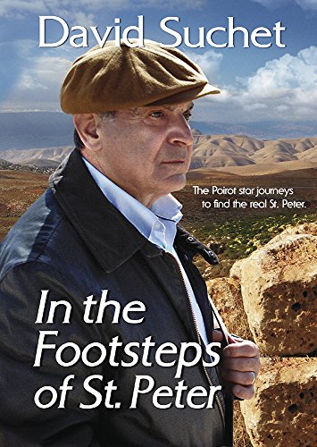 David Suchet in a cap, standing in a rocky landscape.