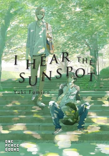 Book with dark or muted cover, possibly featuring sun or light symbolism, rectangular shape.