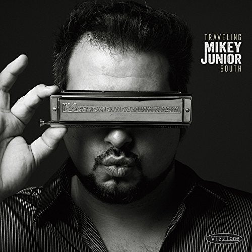 Black and white album cover featuring a man holding a harmonica.