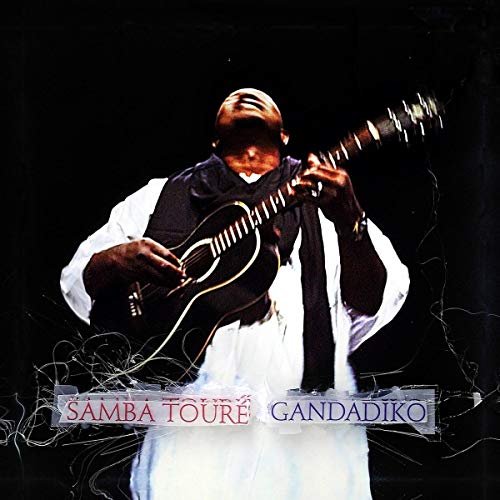 Samba Touré playing a stringed instrument, album cover for Gandadiko.