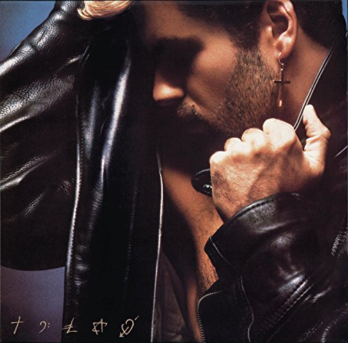 Close-up of George Michael in a leather jacket, holding a cross.