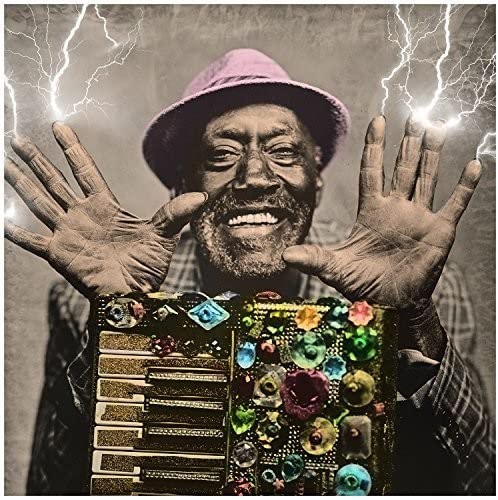 Man with raised hands and decorated washboard, lightning background.