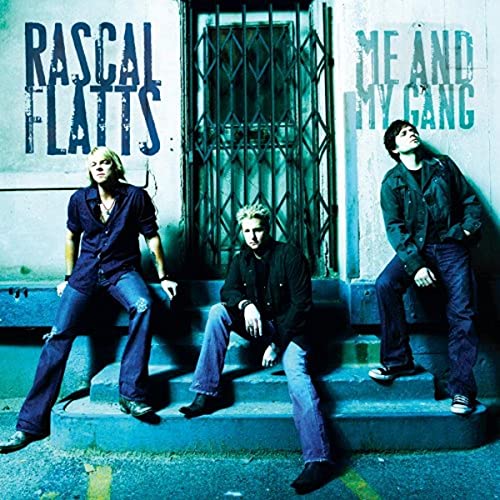 Rascal Flatts album cover: three men posing in front of a metal gate.