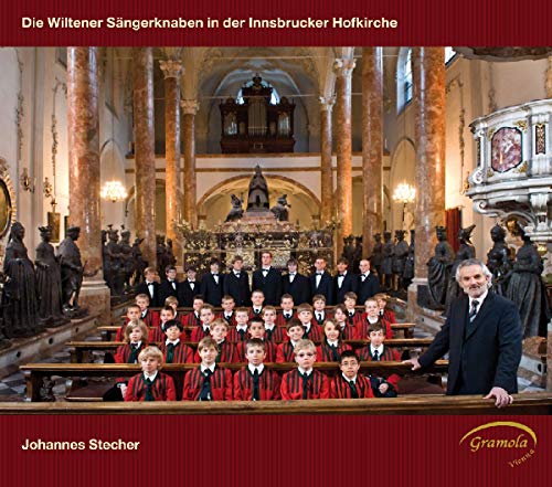 Boys choir in ornate church interior, with conductor on the right.